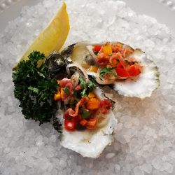 Oyster Casino on a bed of rock salt with lemon and parsley.